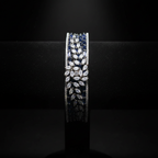 Navy blue baguette AD bangle with white marquise leaf overlay on dark velvet studio display