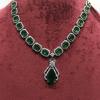 Close-up macro of emerald cushion-cut stones and AD halo