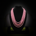 5-strand pink rondelle bead necklace on dark velvet studio display