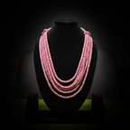 5-strand pink rondelle bead necklace on dark velvet studio display