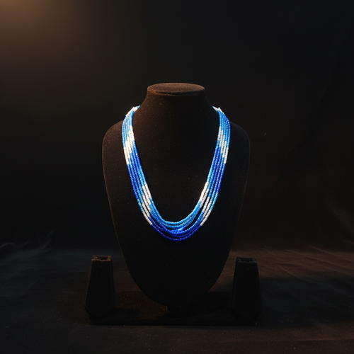 5-strand blue and white ombre seed bead necklace on dark velvet studio display