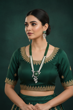 Bridal lifestyle — model wearing emerald bead and pearl AD botanical pendant long necklace set