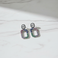 Pastel Rainbow CZ Open Rectangle Earrings – luxury flat lay on marble