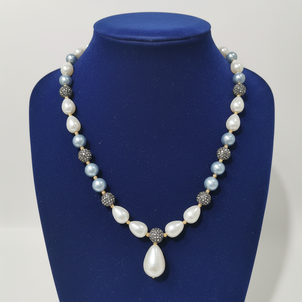 Powder blue pearl and grey AD disco ball long necklace with baroque drops on navy velvet display