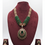 Emerald green bead and gold AD peacock fan pendant long necklace set on burgundy velvet display