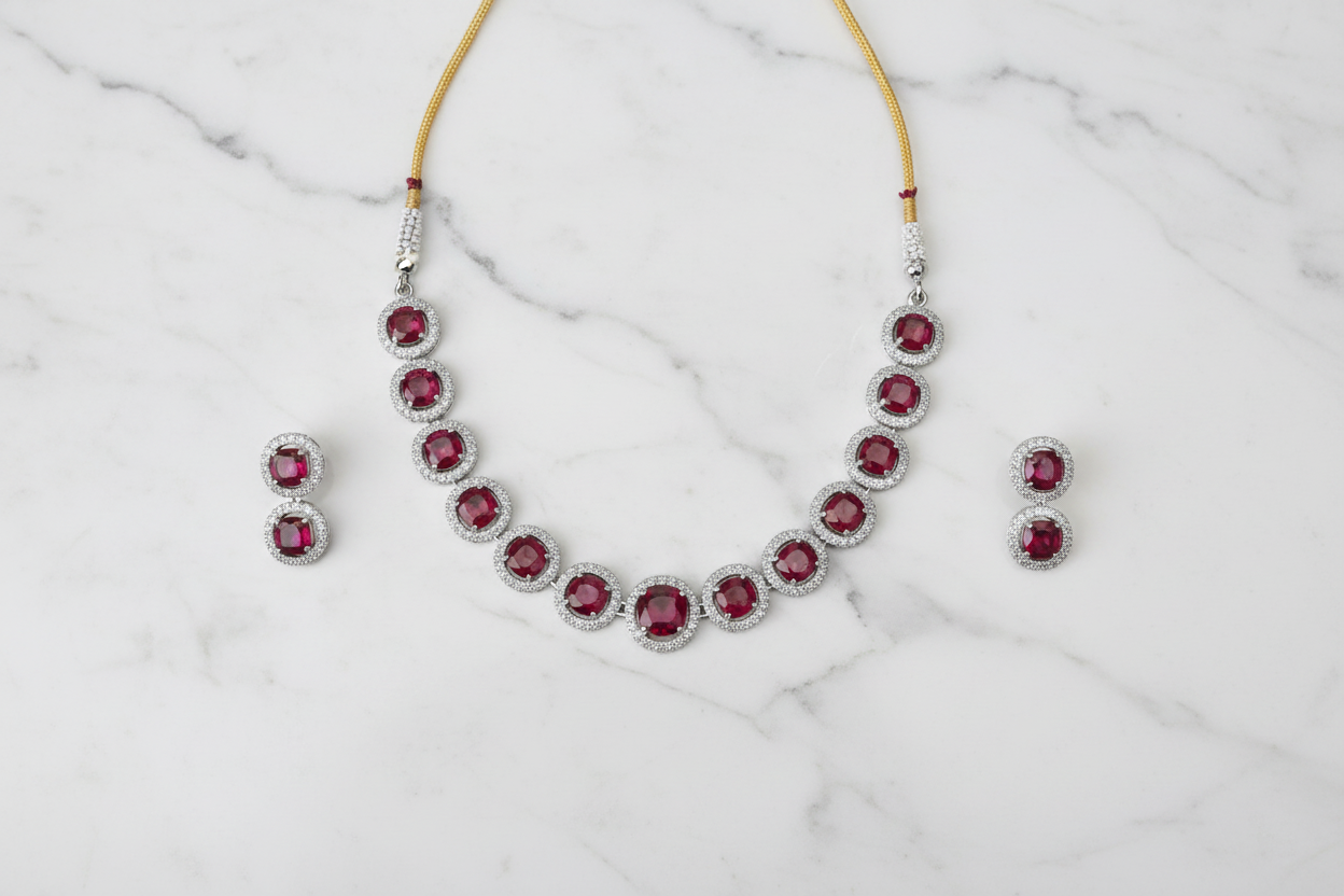 Ruby round halo AD necklace set flat lay on white marble