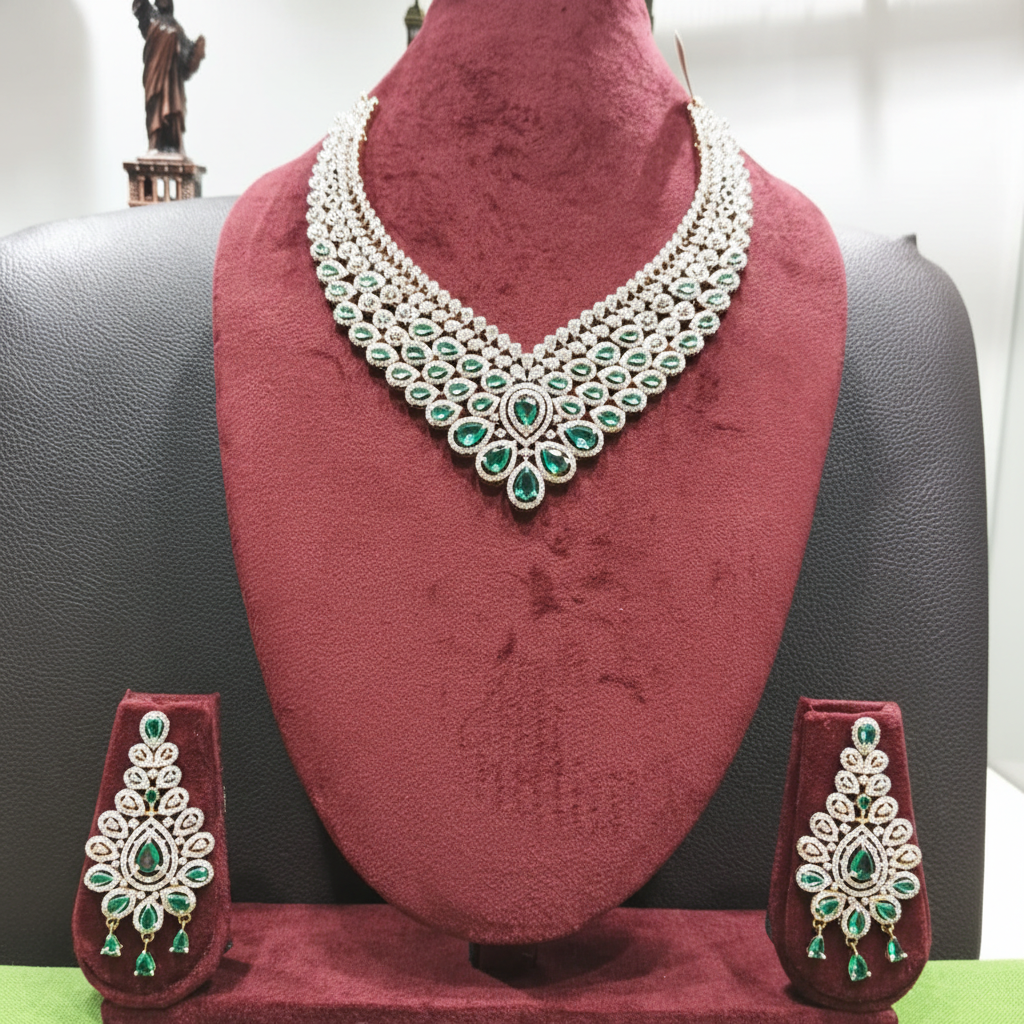 White AD and emerald green V-shape bridal necklace set on burgundy velvet display