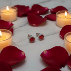 Ruby red CZ round halo stud earrings on white marble with rose petals - romantic lifestyle style