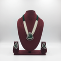 Pearl and emerald bead AD peacock pendant long necklace set on burgundy velvet display