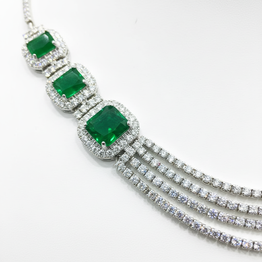 Close-up macro of emerald cushion stones and AD chain strands