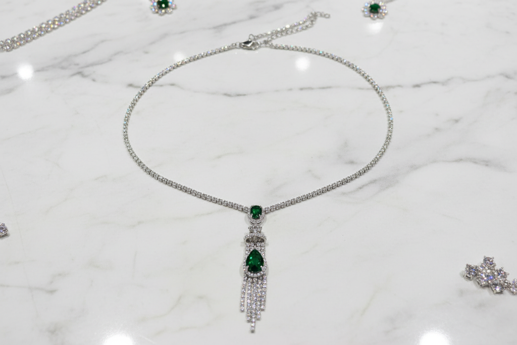 Emerald AD chain necklace flat lay on white marble
