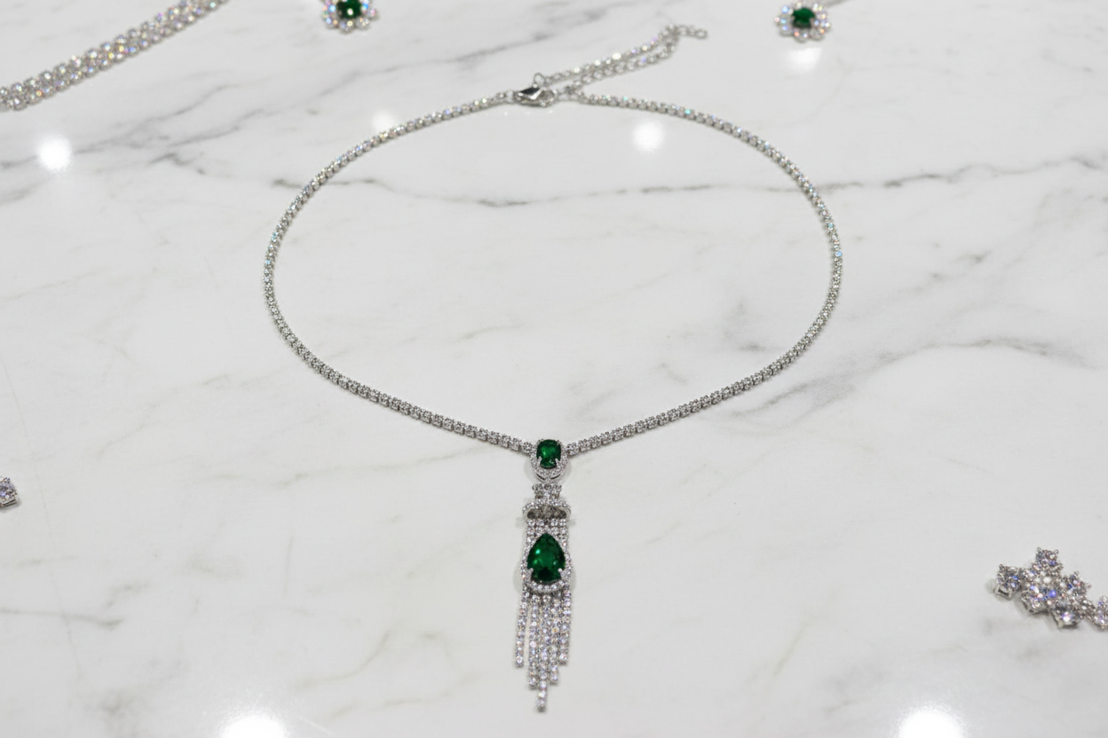 Emerald AD chain necklace flat lay on white marble