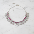 Ruby emerald-cut diamond teardrop necklace editorial promotional image on marble