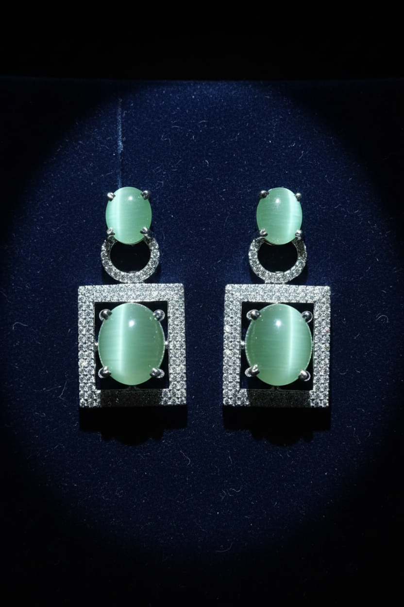Cat's Eye Chrysoberyl Drop Earrings on dark velvet display