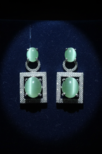 Cat's Eye Chrysoberyl Drop Earrings on dark velvet display