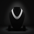 5-strand white seed bead necklace on dark velvet studio display