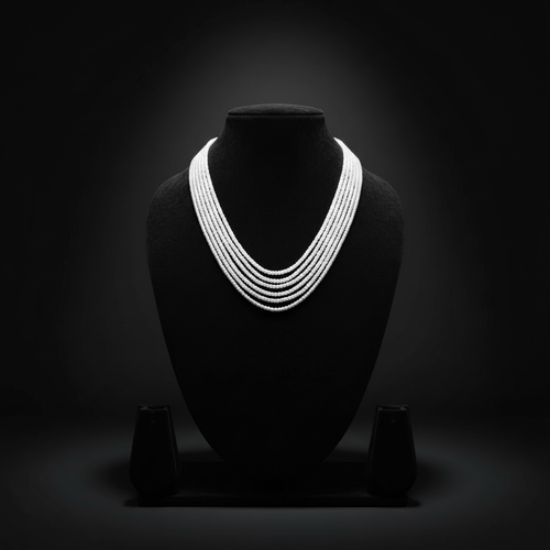 5-strand white seed bead necklace on dark velvet studio display