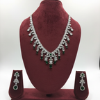 Emerald and diamond AD fringe necklace set on burgundy velvet display