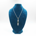 Emerald AD chain necklace on teal velvet display