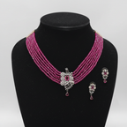 Multi-strand ruby pink crystal bead choker with oxidised silver AD butterfly centrepiece set on black velvet display