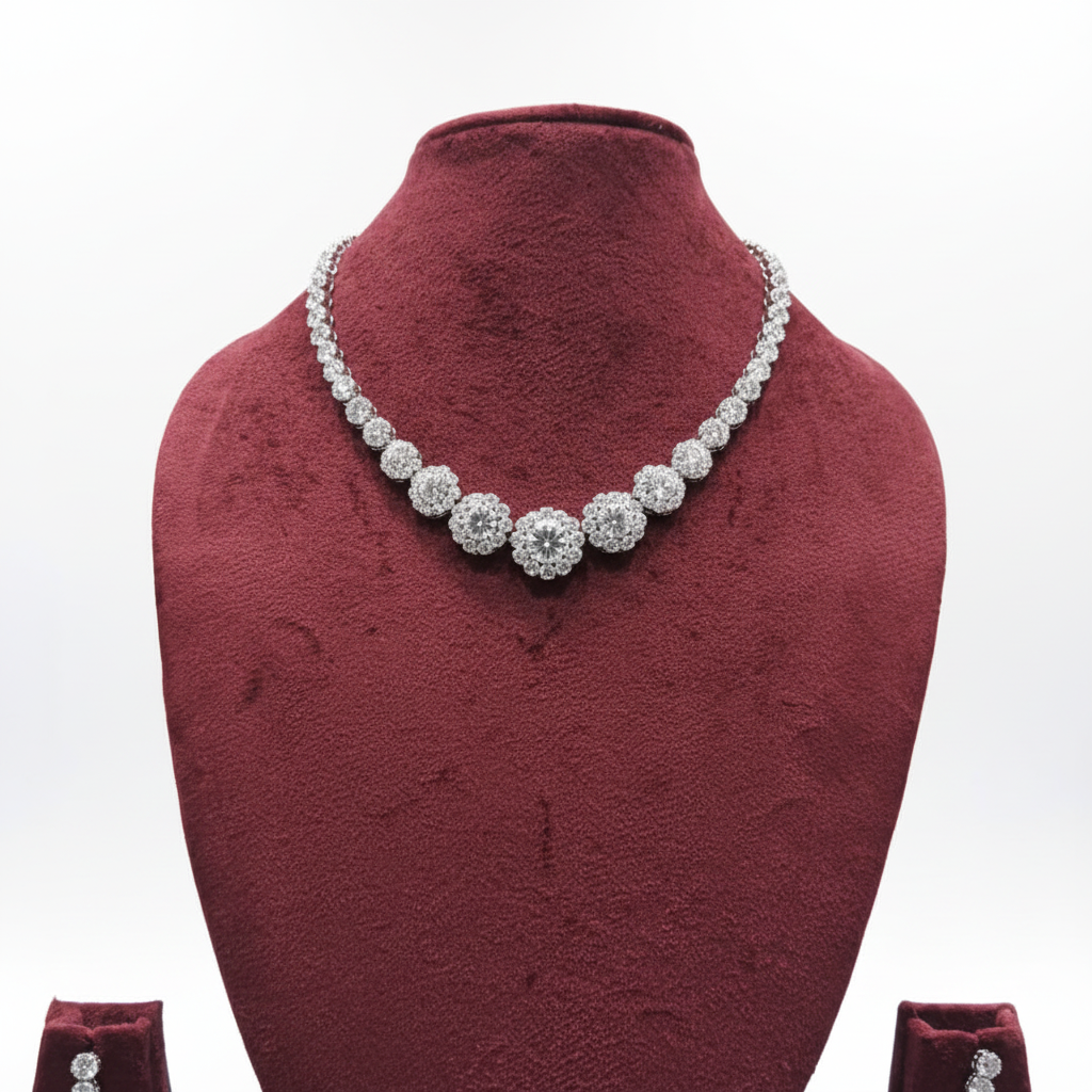 White AD floral cluster graduated tennis necklace set with drop earrings on burgundy velvet display