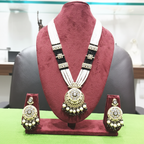 Black bead and pearl AD chandbali pendant long necklace set on burgundy velvet display