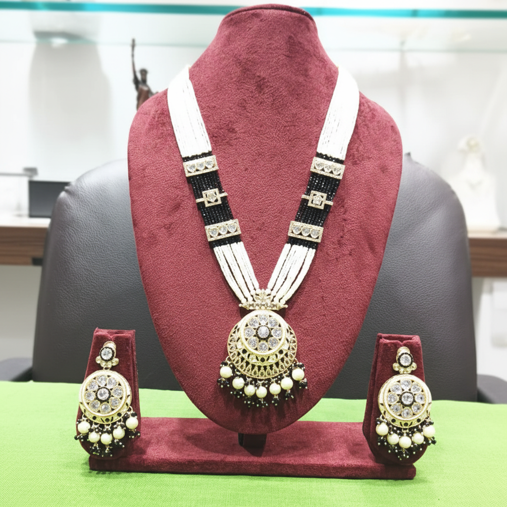 Black bead and pearl AD chandbali pendant long necklace set on burgundy velvet display