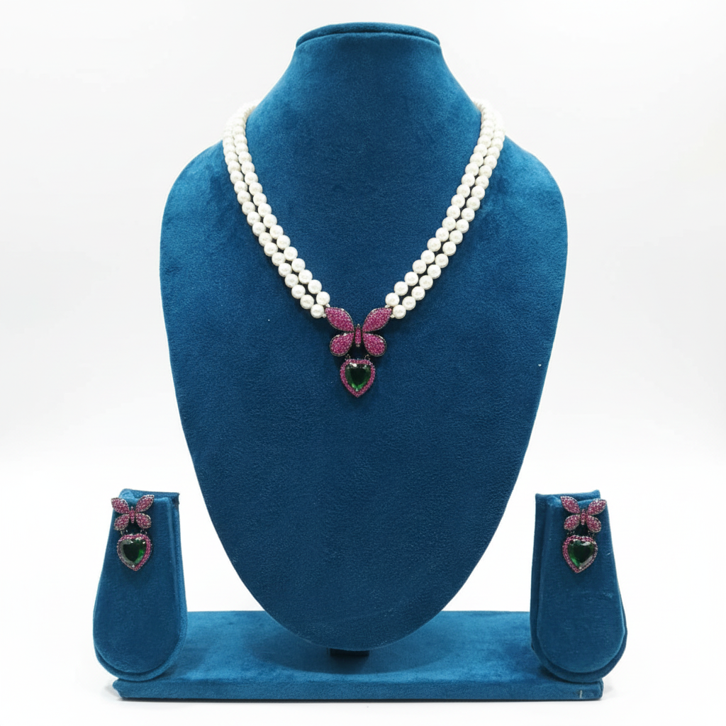 Double-strand pearl and ruby pink AD butterfly bow emerald heart pendant necklace set on navy velvet display