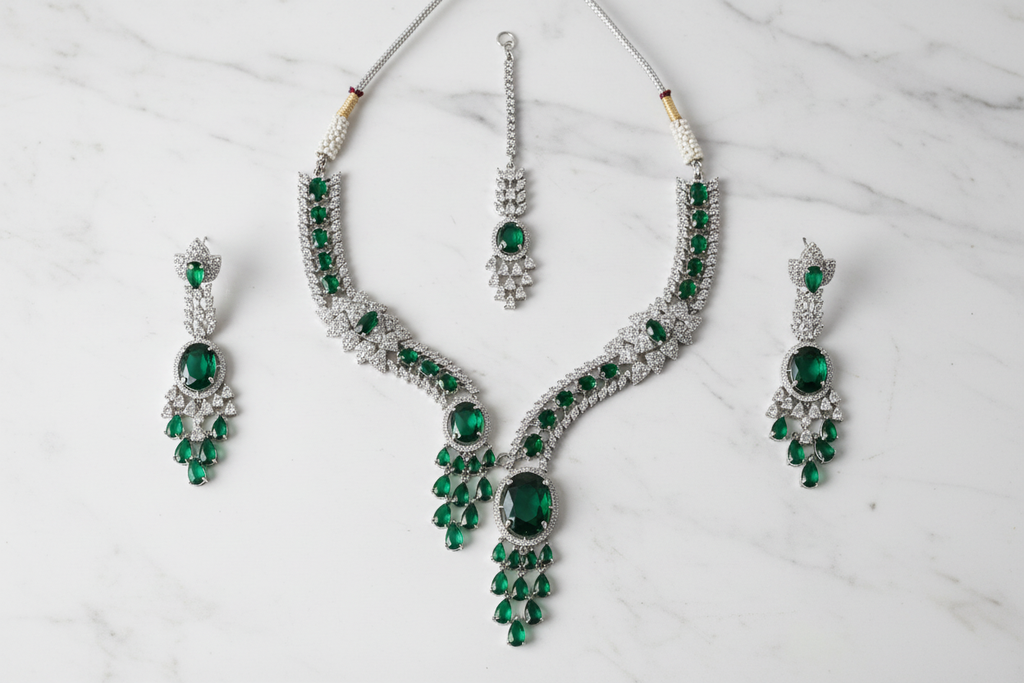 Emerald AD Necklace Set flat lay on marble