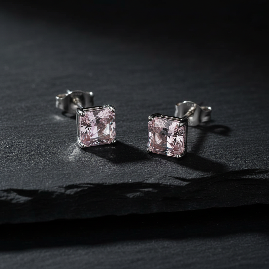 Blush pink CZ princess cut square stud earrings on dark charcoal slate - moody editorial style