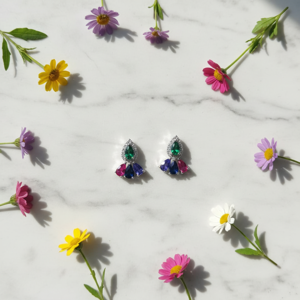 Multicolour CZ cluster drop earrings on white marble with wildflowers - vibrant lifestyle style