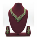 Emerald green and gold AD V-shape fringe waterfall necklace set on burgundy velvet display
