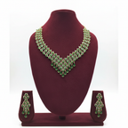 Emerald green and gold AD V-shape fringe waterfall necklace set on burgundy velvet display