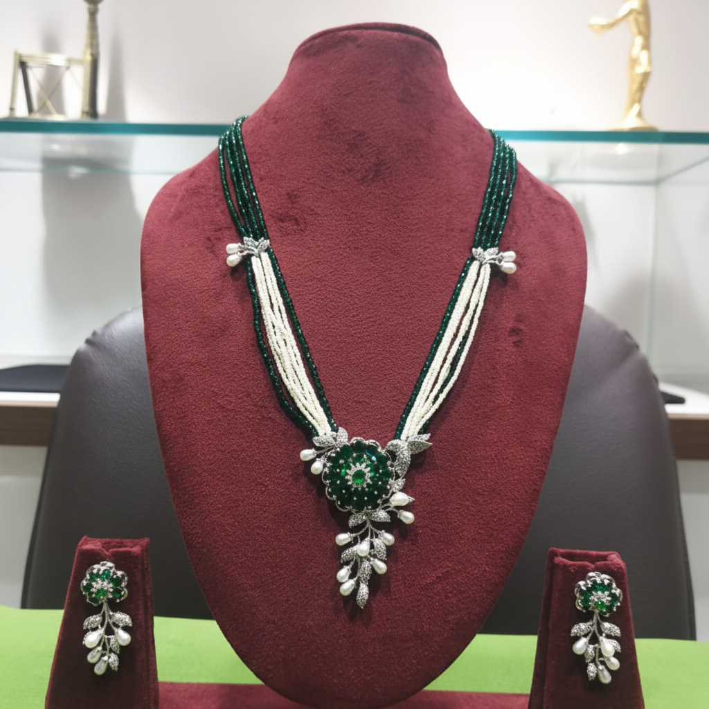Emerald bead and pearl AD botanical pendant long necklace set on burgundy velvet display